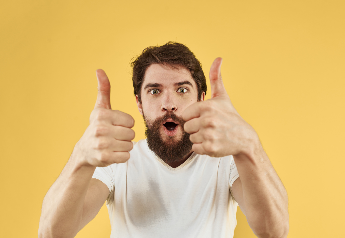 Man in a T-Shirt Positive Gesture with His Hands White T-Shirt Bushy Beard
